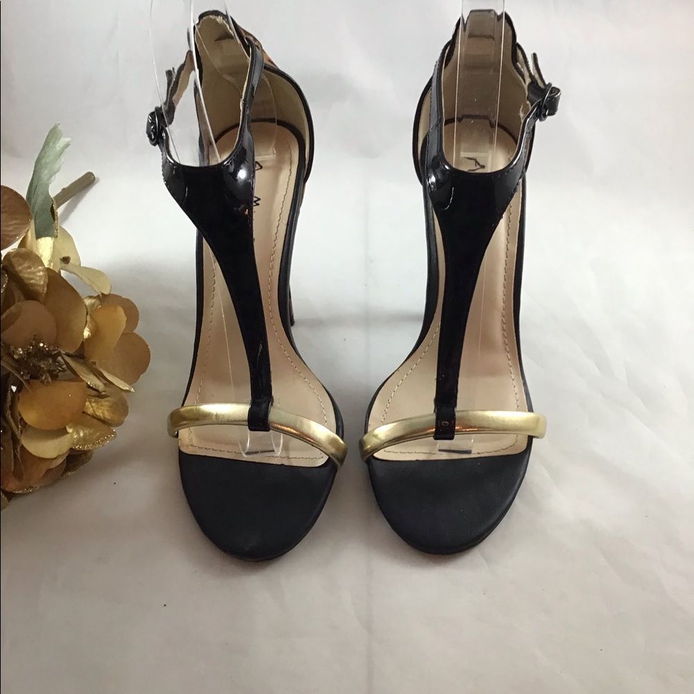 Anne Michelle cheetah sandal trimmed in gold and patent leather size 7.
